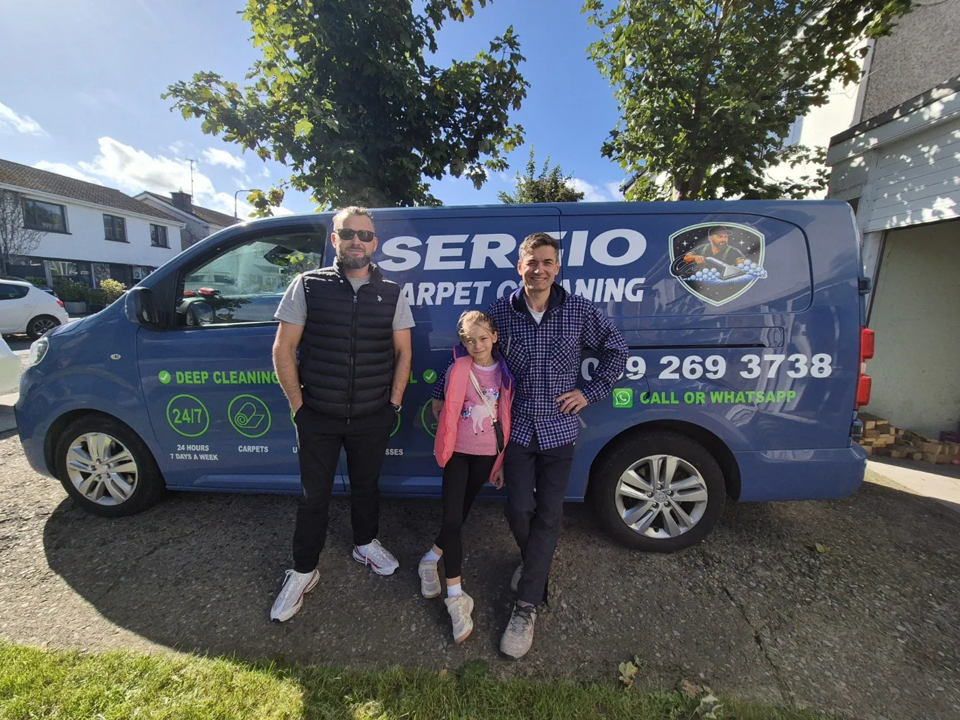 Sergio and Tony team by their branded van